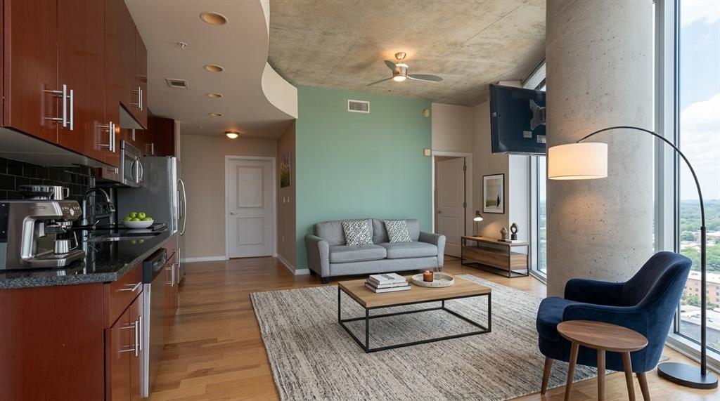 Open-concept living room with skyline views and cherrywood kitchen