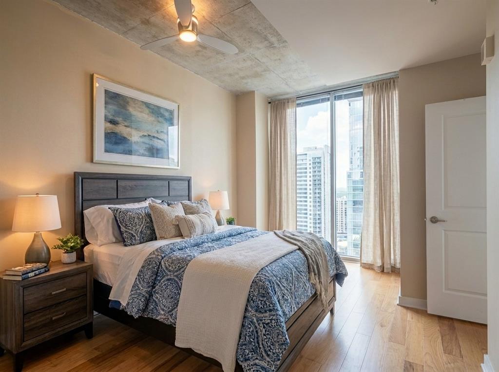 Bedroom with floor-to-ceiling windows and downtown Austin views