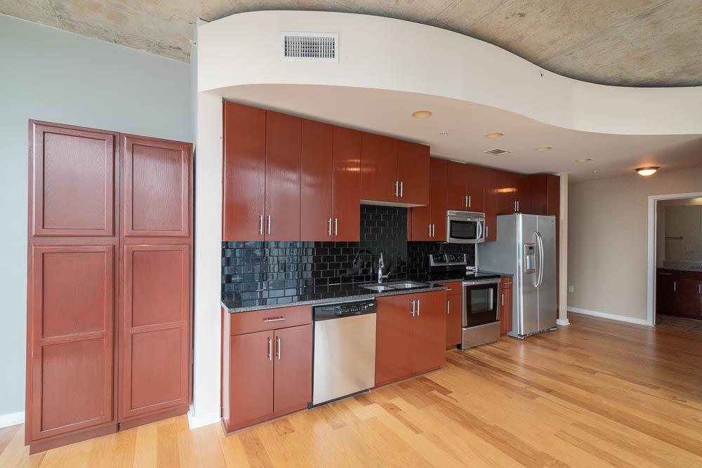 Kitchen with granite counters, cherrywood cabinetry and stainless steel appliances